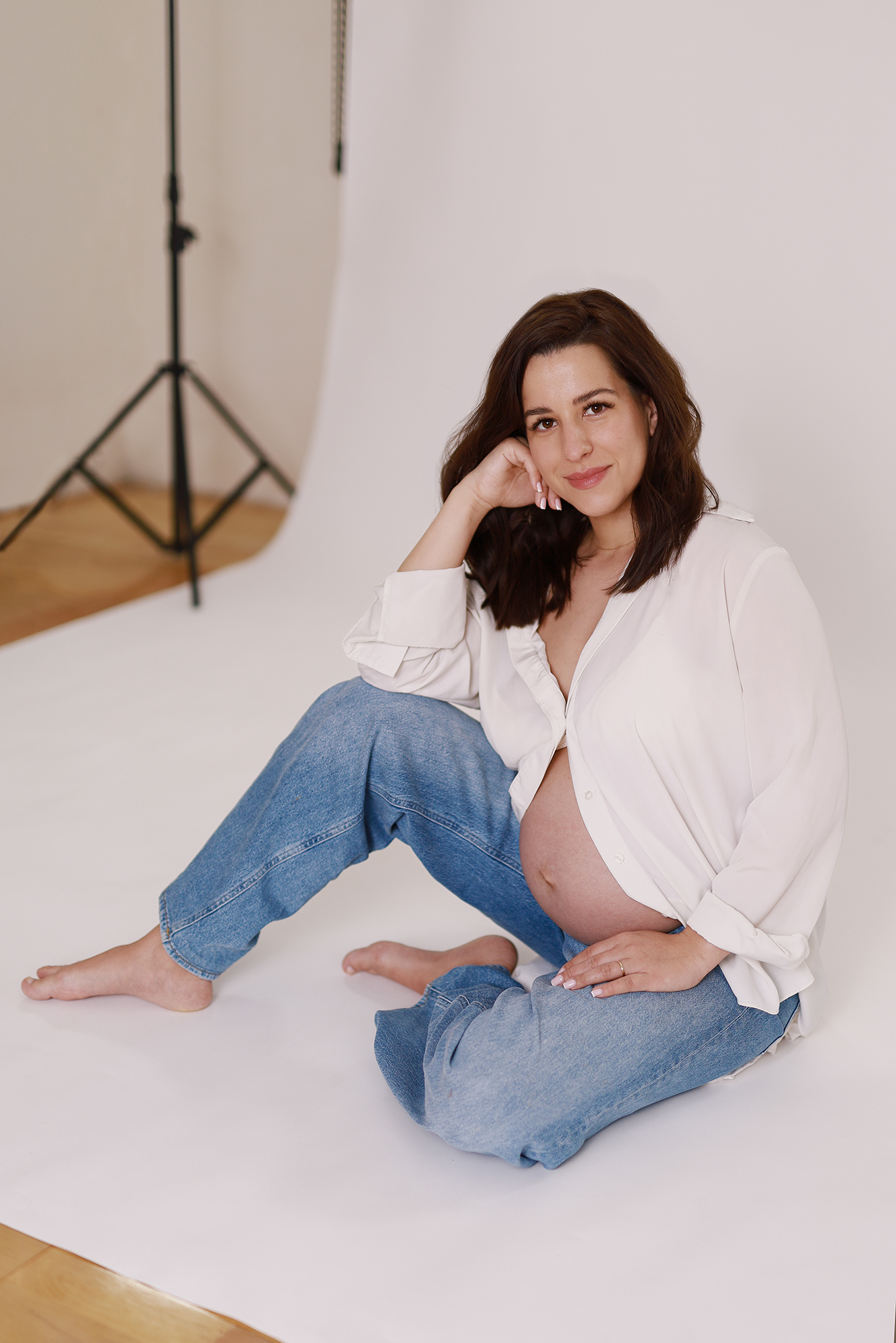 kismama laza, hétköznapi ruhában, divatosan pózol miskolci stúdióban, minimál stílusban.